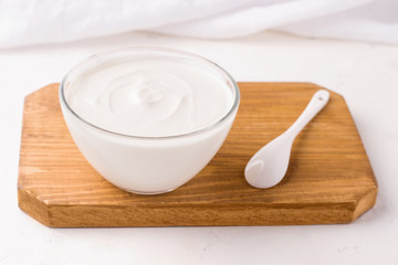 Dahi Indian milk snack on a wooden board on a white background