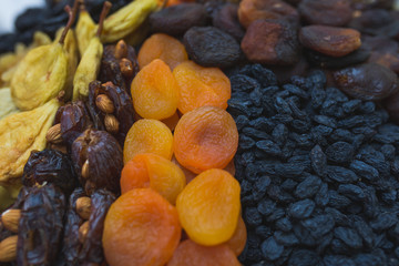 Dried fruits and dried berries on the counter of a small farmers market.