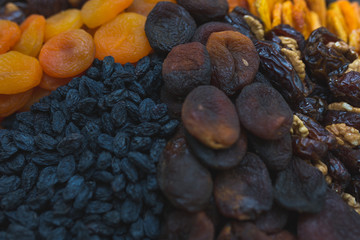 Dried fruits and dried berries on the counter of a small farmers market.