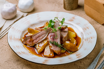 Duck breast with berry sauce and potatoes