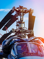 Military helicopter rotor blade and folded blades closeup on background blue sky