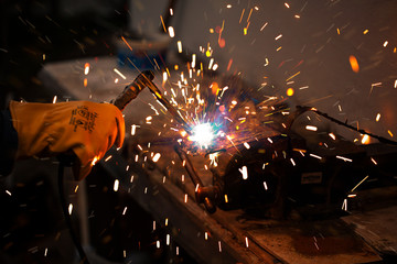 Industrial welder.Welder working on a weld metal with professional mask.

