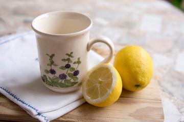 cup of chamomile tea with lemon on a neutral background