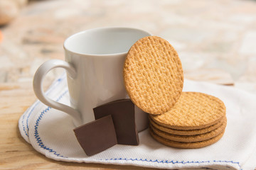 Cup of coffee with oatmeal cookies on a napkin.