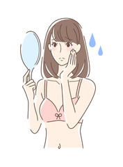 不安な表情で手鏡を見る女性
