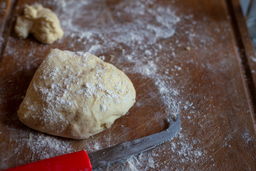  Bread dough  on floured board ,making bread rolls at home.