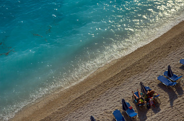 Fototapeta na wymiar People are sunbathing on the sandy beach