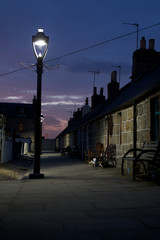 Footdee Fishing Village in Aberdeen lit by gaslamp at night
