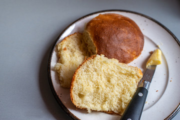 home made bread rolls on plate with butter & knife.home cooking.hobby,