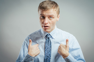 Closeup portrait of angry, unhappy, annoyed young man, getting mad, asking question: you talking to me, you mean me? Isolated on white background. Negative human emotion, facial expression, feelings - 339976492