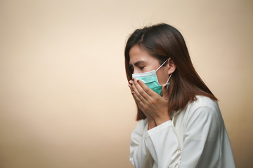 Woman wearing mask and feeling sick and she suffer from cough with medical mask protection