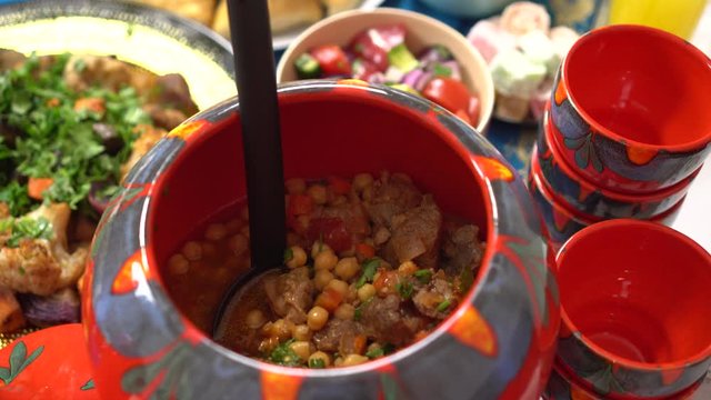 Harira, a soup with lentils, chickpeas and favas, is a staple of Ramadan in Morocco. Ramadan Fasting, Iftar food. Muslim family having dinner