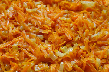 Fried onions and carrots in a pan