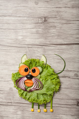 Angry cat made of salad and onion