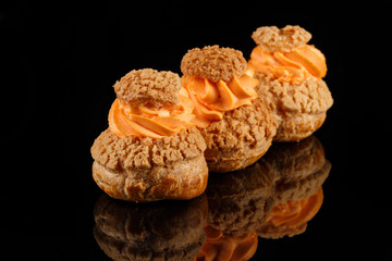 Cream CHOUX dessert. Set of 3 pieces. Black background with reflection. Art of pastry