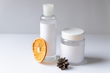 Cosmetic bottle for liquid, cream, gel, lotion. Hand sanitizer. Organic natural science beauty product. Battle with slice of orange