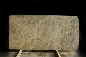 A large slab of natural beige stone with small veins is called Emperador Light marble