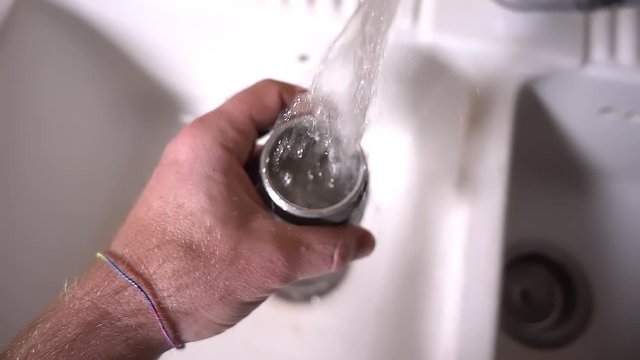 making coffee at home - man's hands washing moka under running water