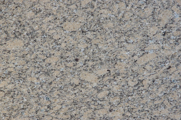 A slab of natural beige stone with small spots and dots is called Phoenix Yellow granite