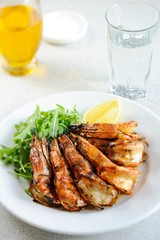 Grilled Shrimp with lemon on the plate - Close-up