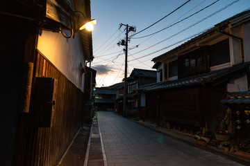 Fototapeta na wymiar Takehara Townscape Conservation Area in dusk. The streets lined with old buildings from Edo, Meiji periods, a popular tourist attractions in Takehara city, Hiroshima Prefecture, Japan