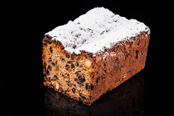 Raisins kulich bread sprinkled with powdered sugar on top. Confectionery photography concept.