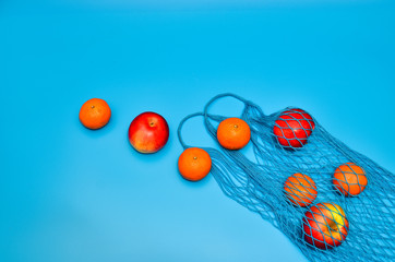 Healthy food shopping. food photography of designer handbag made from different fruits and vegetables on blue table