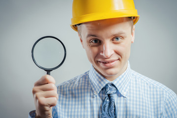builder with magnifying glass