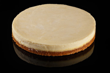 True Cheesecake. Whole cake. Art of sweets. Content for pastry shop and bakery. Traditional culinary. Black backdrop