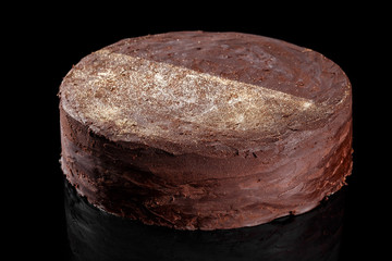 Lava chocolate cake with gold edible glitter on top. Confectionery photography concept in black background.