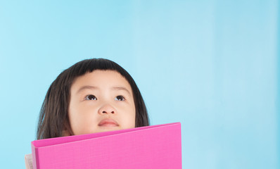 Cute Asian girls are holding a file folder for new ideas.