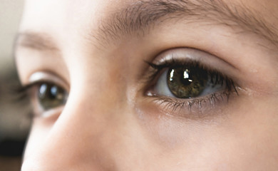 Thoughtful eyes of a teenage boy man close-up.