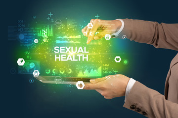 Close-up of a touchscreen with SEXUAL HEALTH inscription, medical concept