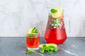 homemade lemonade with strawberries, mint and lemon, jug and glass with summer refreshing cocktail