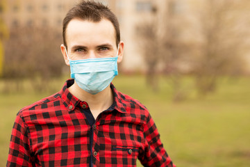 Portrait of young man wearing face mask protecting from air pollution