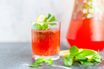 homemade lemonade with strawberries, mint and lemon, jug and glass with summer refreshing cocktail