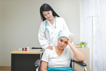 Obraz premium Asian female doctor provided treatment for patients sitting in a wheelchair, taking care closely. Cancer treatment hospital concept, health insurance