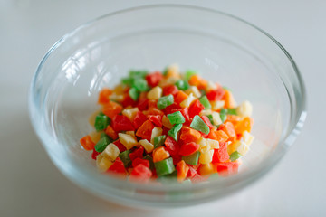 Transparent glass container with colored candied fruits in it
