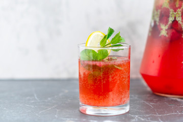 homemade lemonade with strawberries, mint and lemon, jug and glass with summer refreshing cocktail