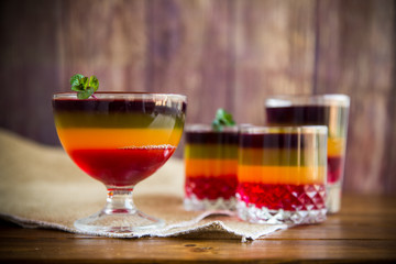 Sweet multi-colored fruit puff jelly in a glass cup