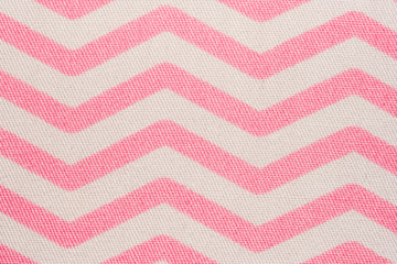 Pattern of pink and white striped zig zag. Macro textile texture