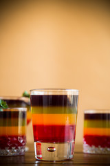Sweet multi-colored fruit puff jelly in a glass cup