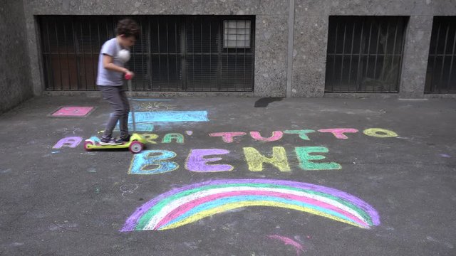 Europe, Italy , Milan  -  Italian children and parents draw  the inscription everything will be fine ( tutto andra' bene )during n-cov19 Coronavirus epidemic - quarantine life style - flash mob