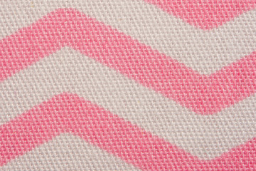 Pattern of pink and white striped zig zag. Macro textile texture