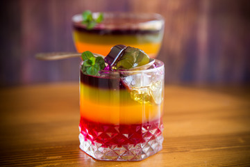 Sweet multi-colored fruit puff jelly in a glass cup
