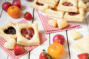 gebackene gefüllte Blätterteigtaschen mit Früchten wie Erdbeeren und Pudding