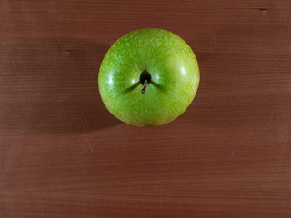 a green apple in overhead view