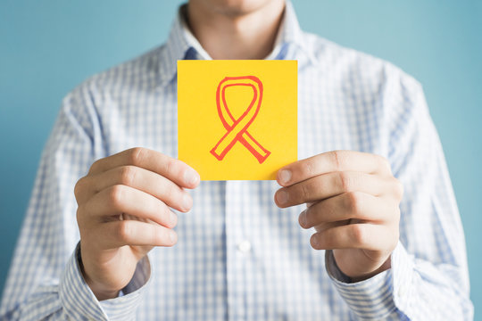 Picture icon in the hand of charity ribbon