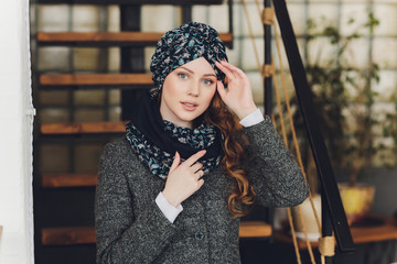 Photo of self assured Arabian lady in hijab, shows you right way, points at blank space with both...