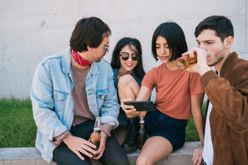 Group of friends watching something in smartphone.